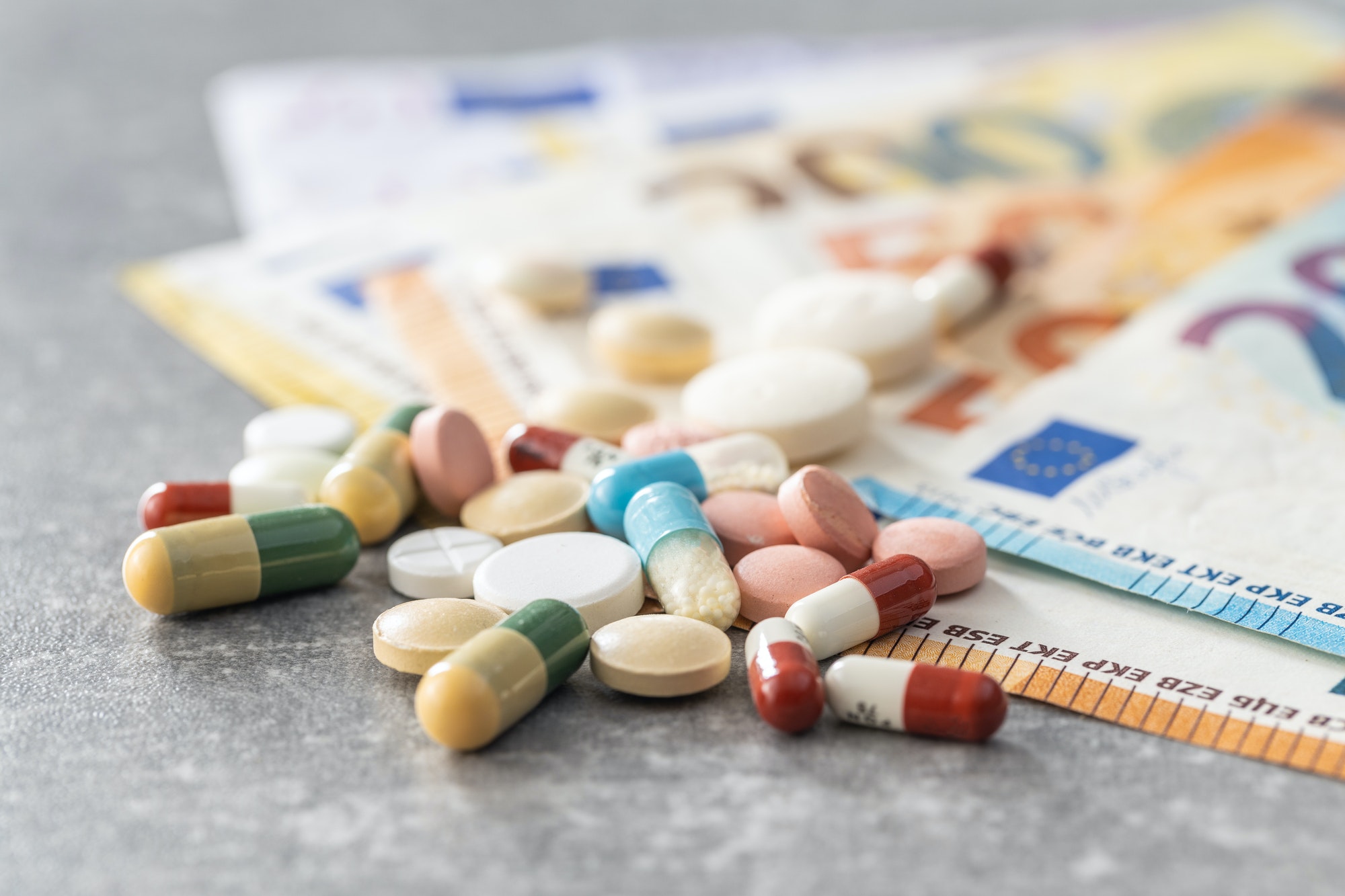 Euro banknotes and pills. Concept of healthcare.